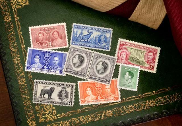 George IV 1937 Coronation stamps on a decorated green and gold background
