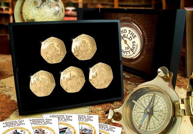 Around the World in 80 Days Gold 50p Set beside a compass