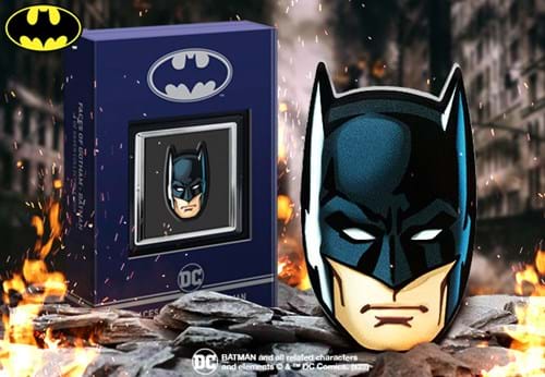 The Face of Batman 1oz Silver Coin on fiery rocks beside box