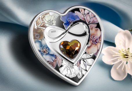 Own The Brilliant Love - Infinity Heart Silver Coin. Struck from Pure Silver, featuring an infinity symbol, floral design, and crystal. The perfect gift for your loved one.